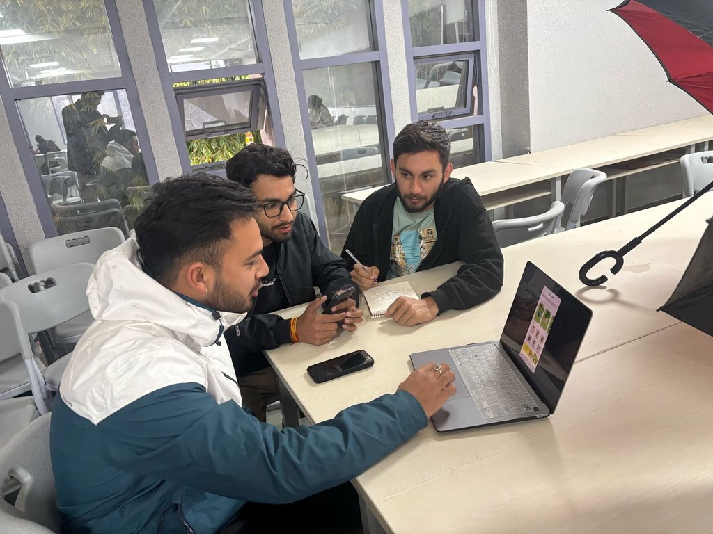 Three team members reviewing the self-checkout flow on a laptop together